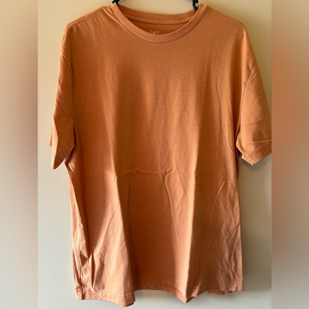 Orange men’s short sleeve tees. One large, one small.